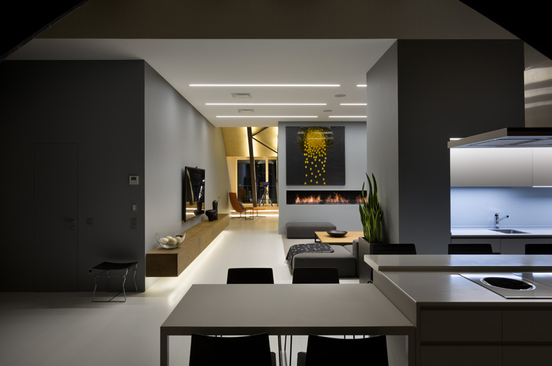 This modern apartment interior has a decorative ceiling element with hidden lighting. #ApartmentDesign #Ceiling #Lighting