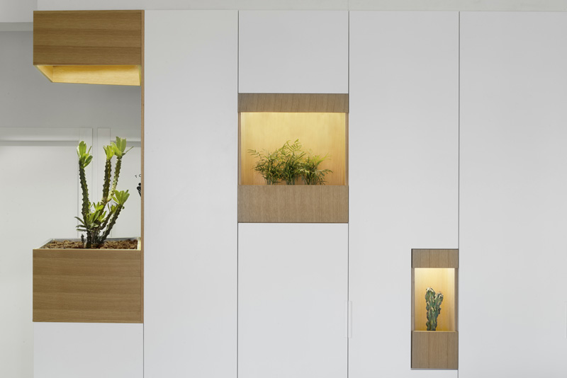 Pockets Of Plants Have Been Added To This White Wall Of Cabinets