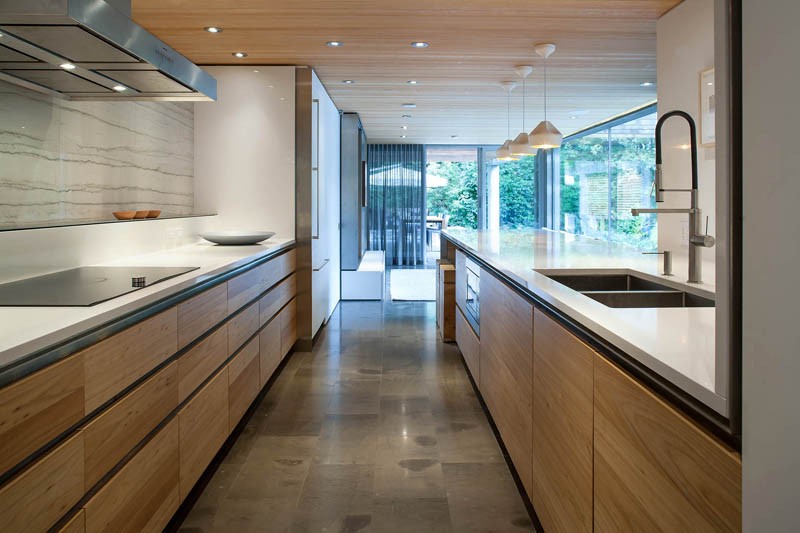 White countertops and wood cabinets in a contemporary kitchen