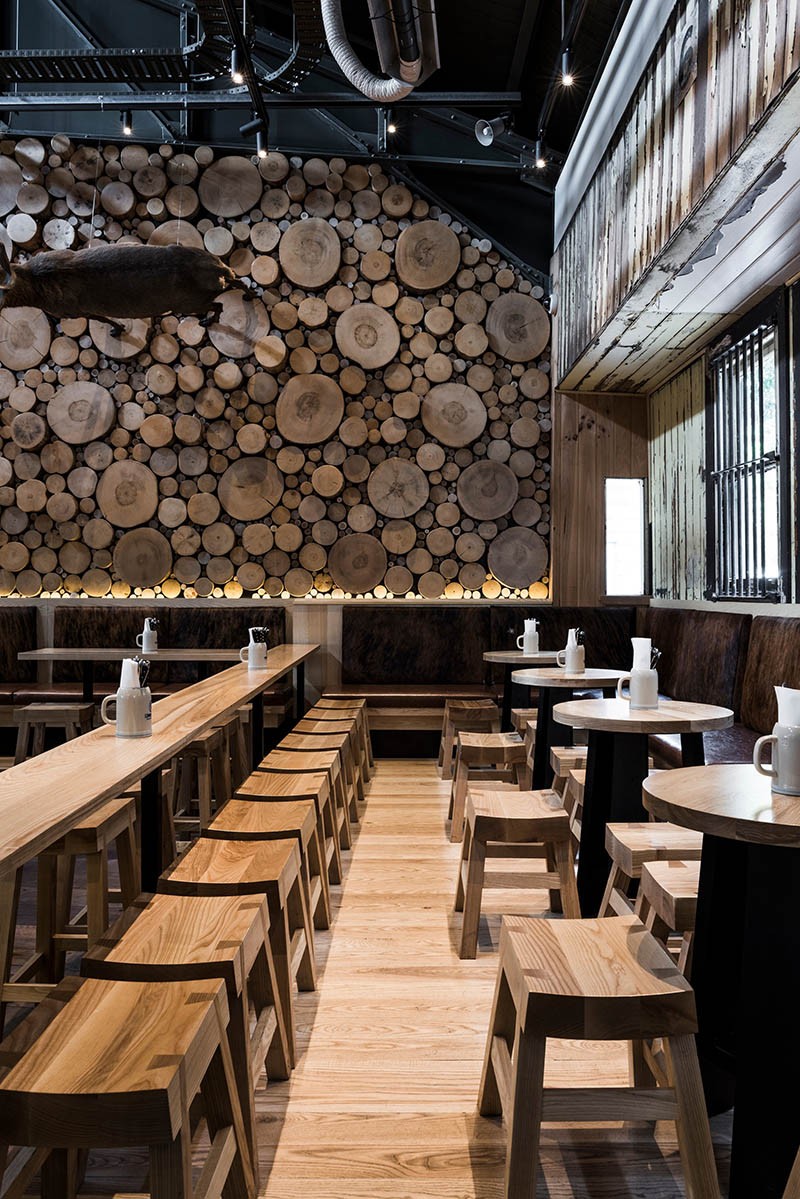 A Giant Log Wall Is A Focal Point In This Restaurant In Australia