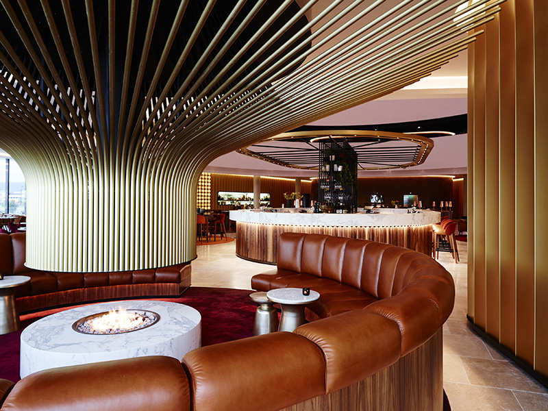 Design Detail - A Large Central Fireplace Stands Out In This Hotel Bar