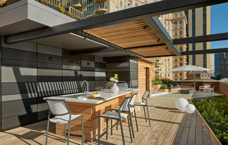 7 Design Lessons To Learn From This Awesome Roof Deck In Chicago // Define the uses of your deck -- With this design, they split the deck into different areas like food and dining, a seating area for gatherings, and a sun deck for lounging.