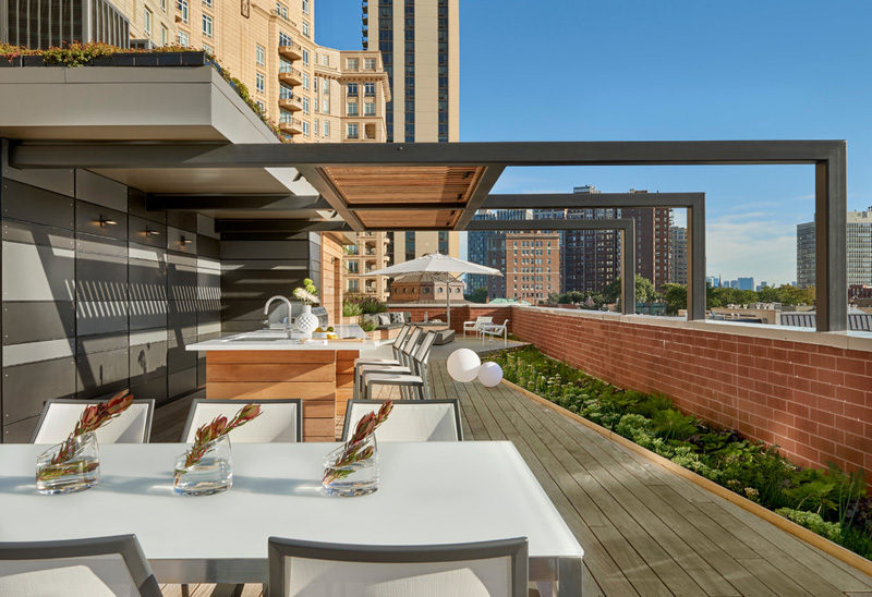 7 Design Lessons To Learn From This Awesome Roof Deck In Chicago // Think about including some shade -- They built a pergola above the kitchen area, and umbrellas have been used throughout the rest of the deck for additional shade protection.