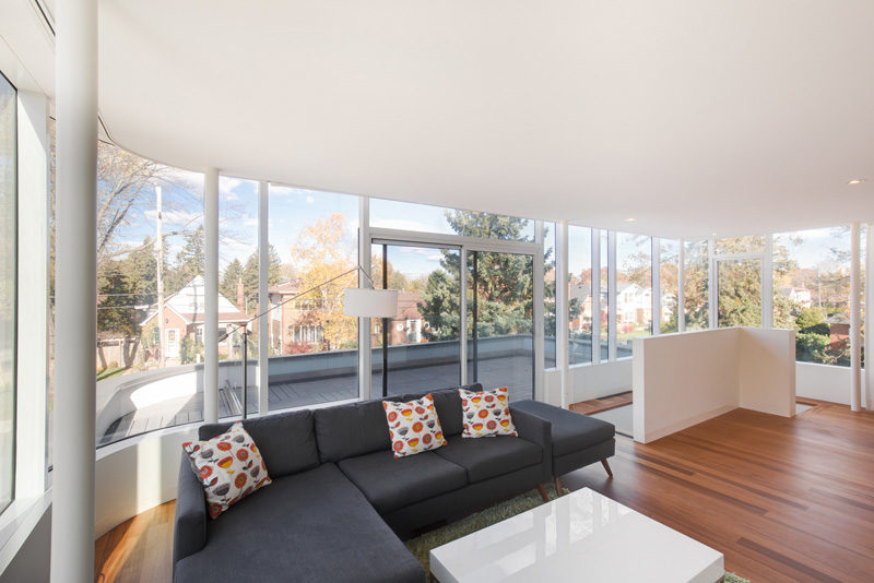 This living space with balcony access, takes advantage of the views with wrap-around windows.