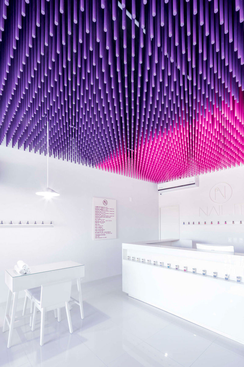 Colorful sticks hang from the ceiling of this nail salon