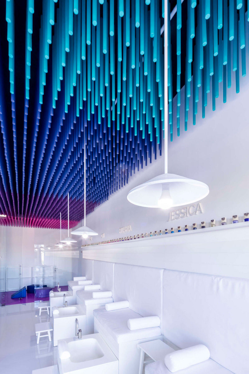 Colorful sticks hang from the ceiling of this nail salon