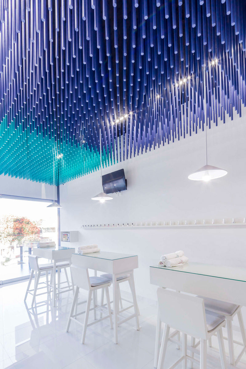 Colorful sticks hang from the ceiling of this nail salon