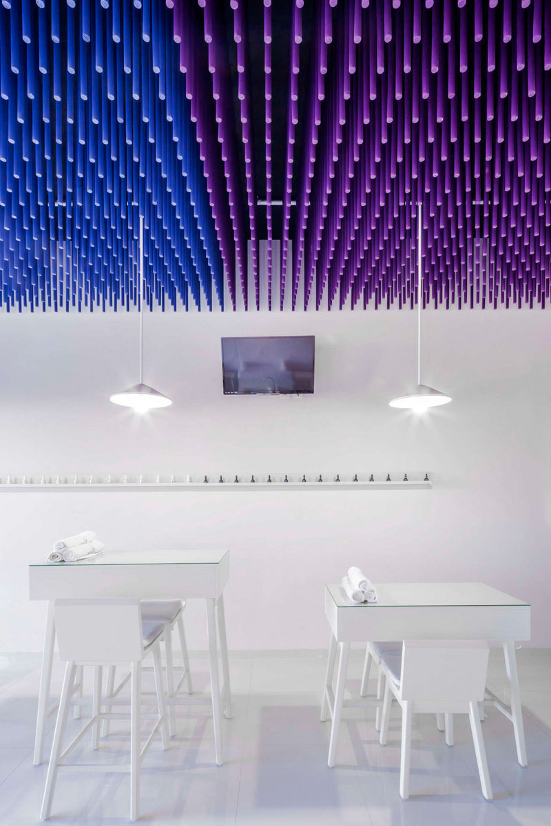 Colorful sticks hang from the ceiling of this nail salon
