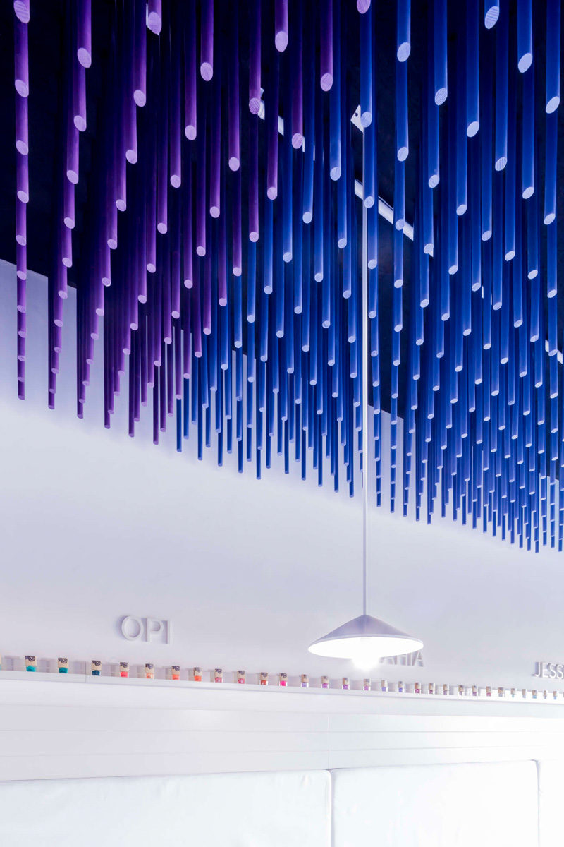 Colorful sticks hang from the ceiling of this nail salon