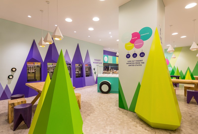 A playful theme of abstract trees and mountains were designed for this frozen yogurt shop