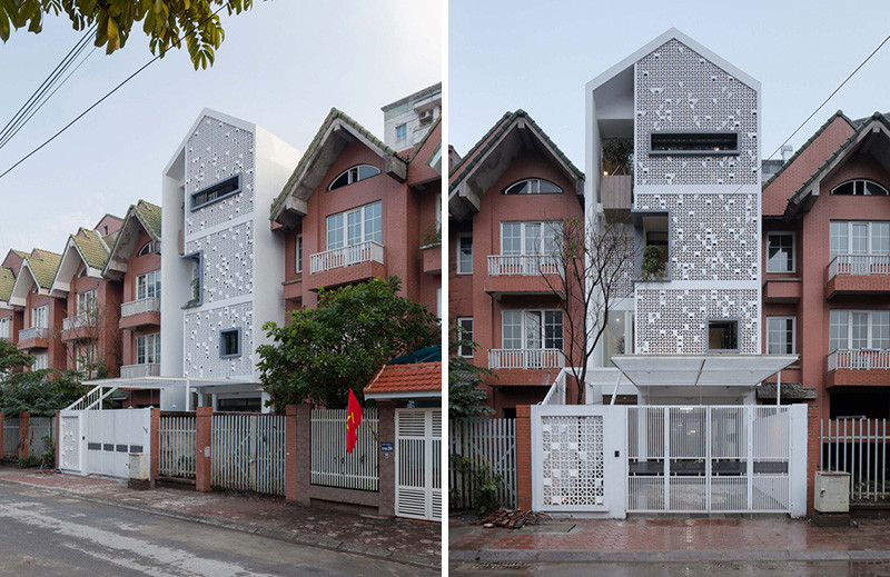 Landmak Architecture renovated a red brick row house in Vietnam, and to stand out from the rest, they surrounded the home with white concrete blocks. #RowHouse #WhiteConcrete #ConcreteBlocks #Architecture