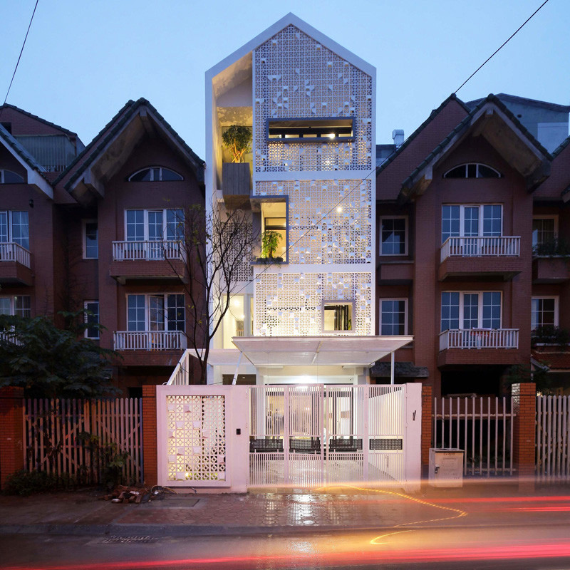 Landmak Architecture renovated a red brick row house in Vietnam, and to stand out from the rest, they surrounded the home with white concrete blocks. #RowHouse #WhiteConcrete #ConcreteBlocks #Architecture