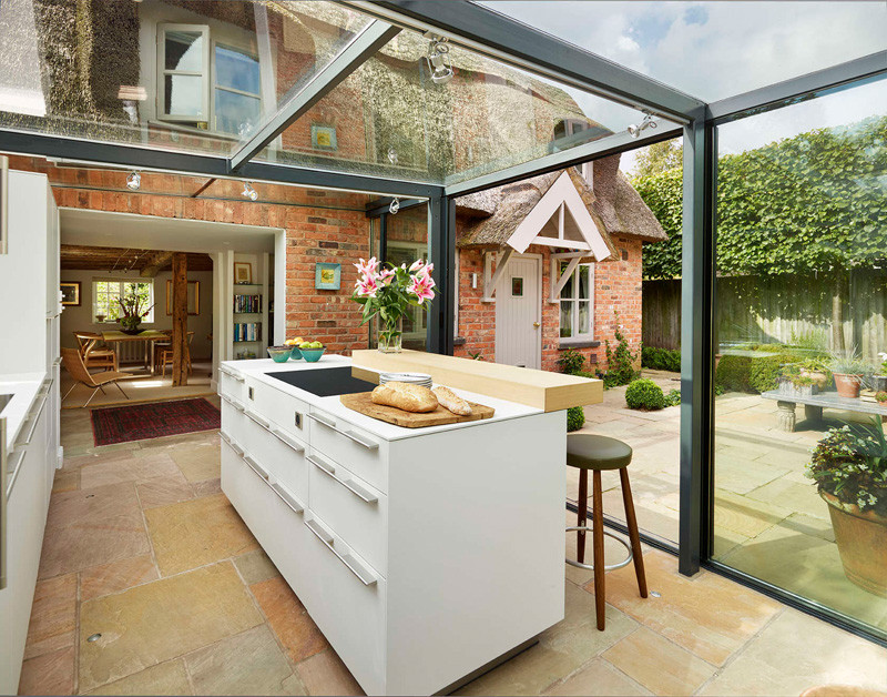 This thatched cottage got a glass box extension