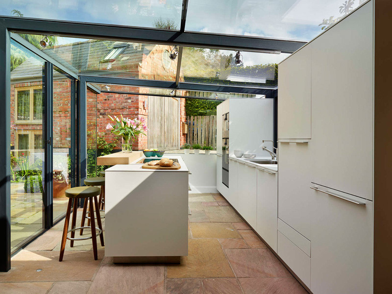 This thatched cottage got a glass box extension