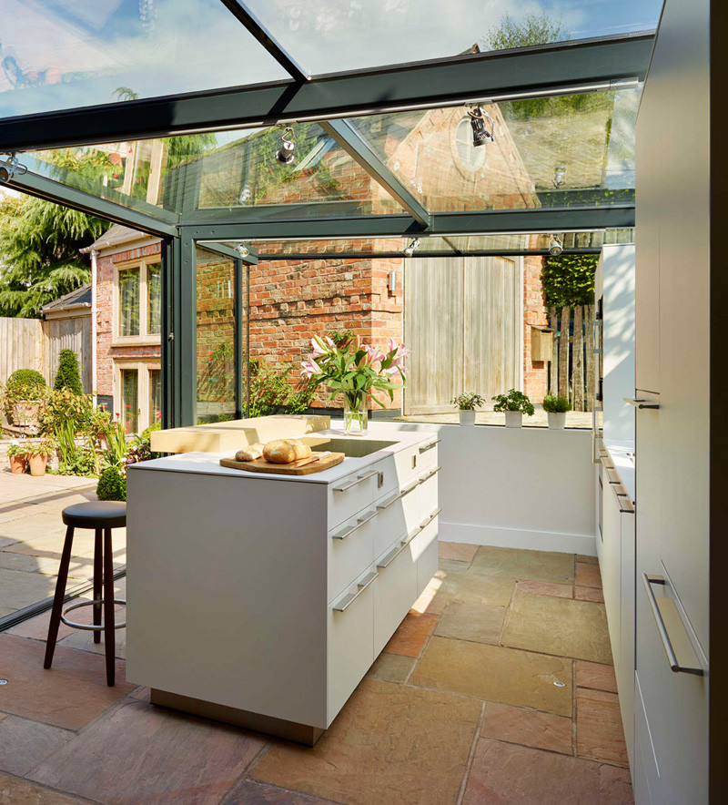 This thatched cottage got a glass box extension