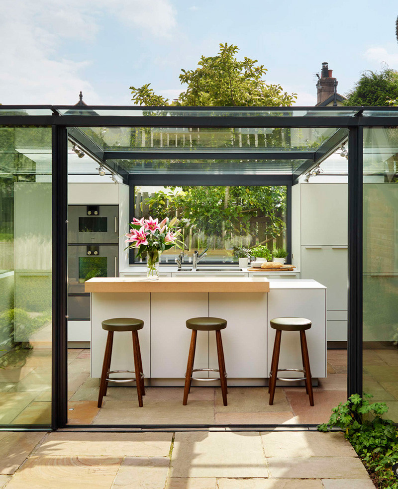 This thatched cottage got a glass box extension for the kitchen