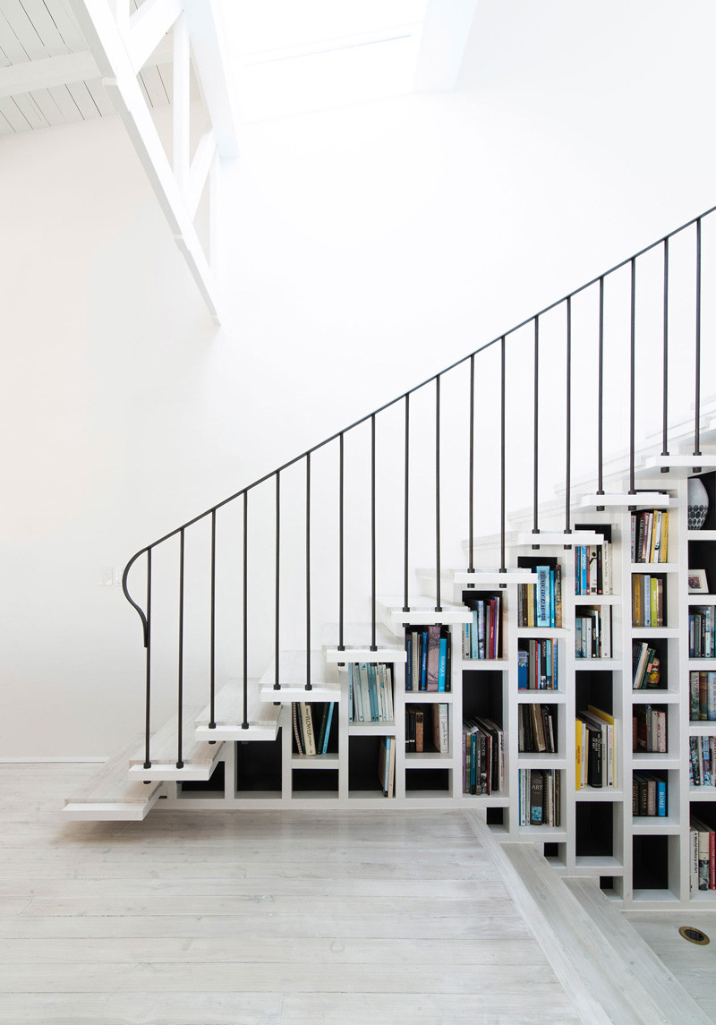 8 examples of stairs that do double-duty as bookshelves