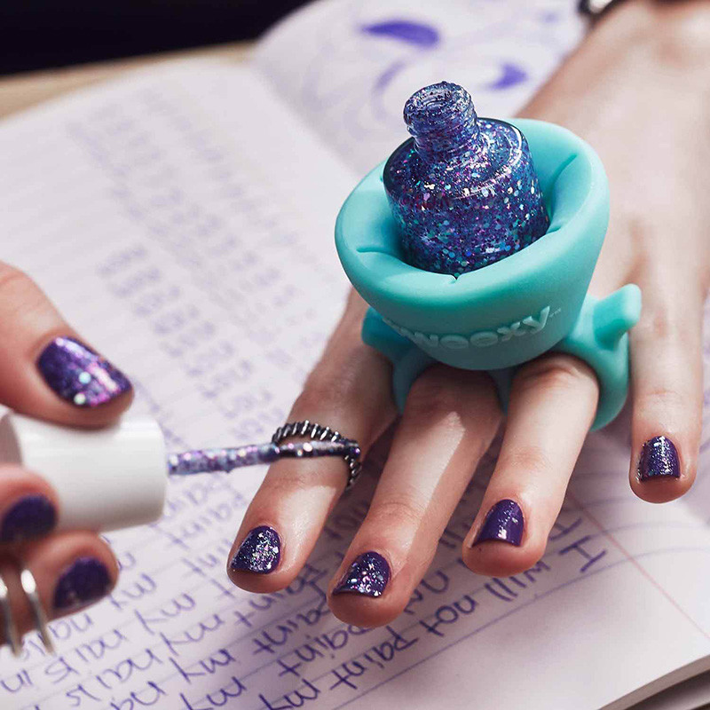 The design of this wearable nail polish holder makes painting your nails easier