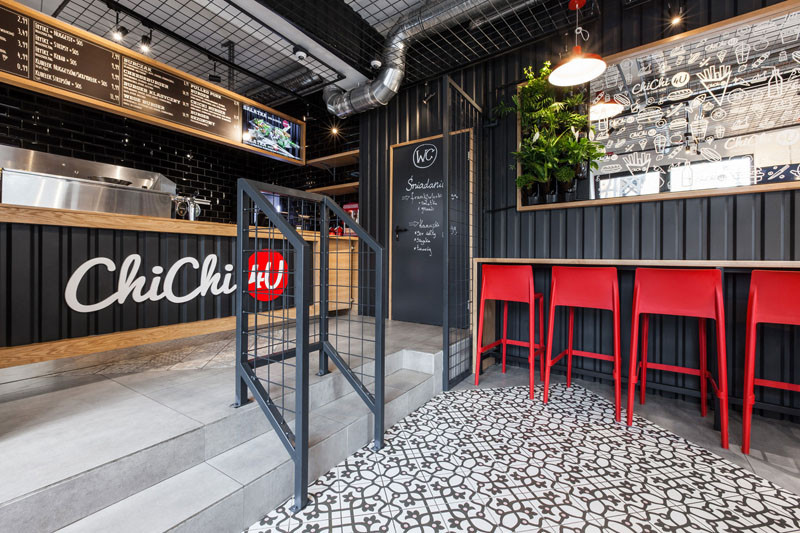 Design detail - The walls of this burger bar are covered in black corrugated steel