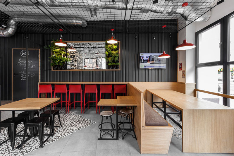 Design detail - The walls of this burger bar are covered in black corrugated steel
