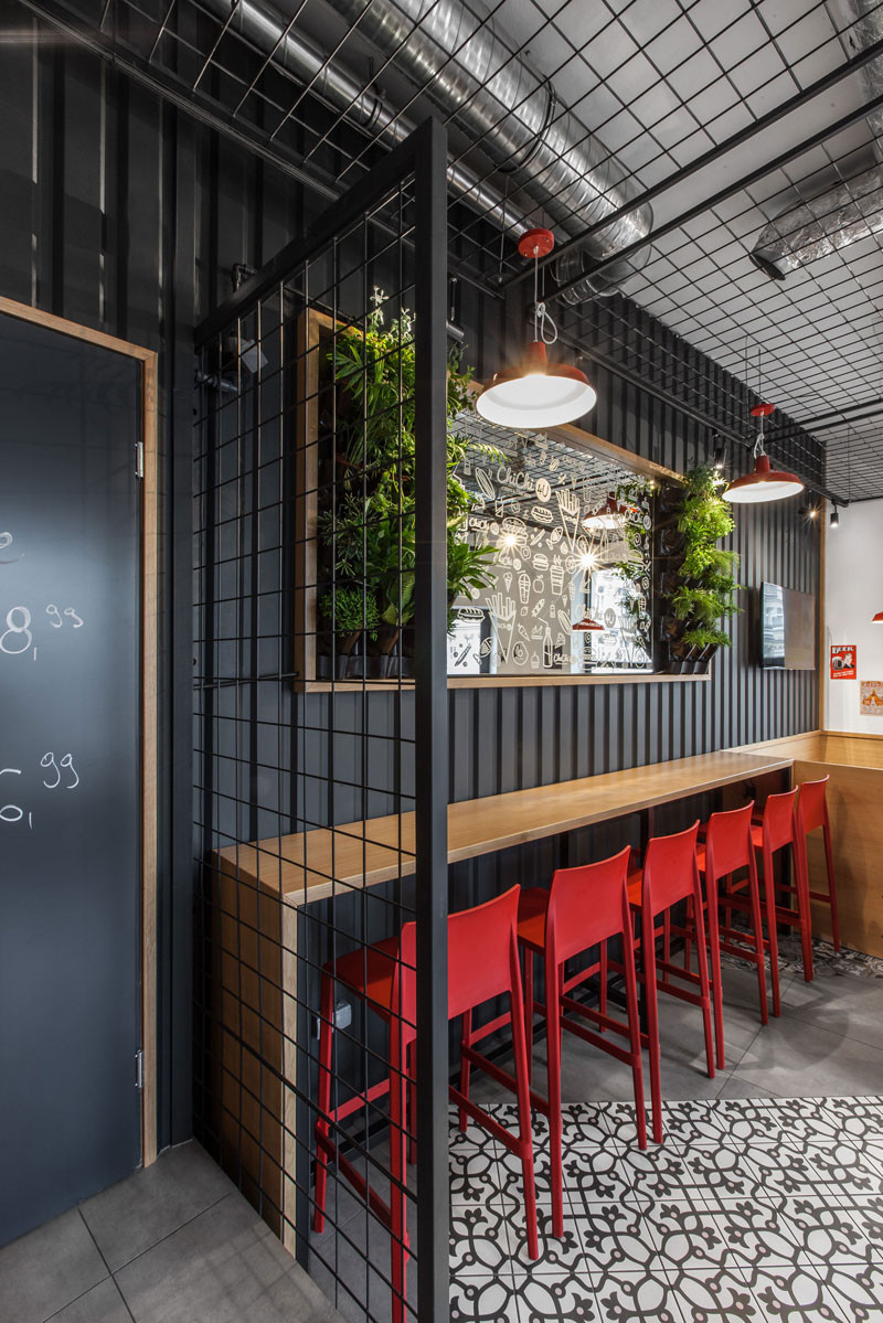 Design detail - The walls of this burger bar are covered in black corrugated steel