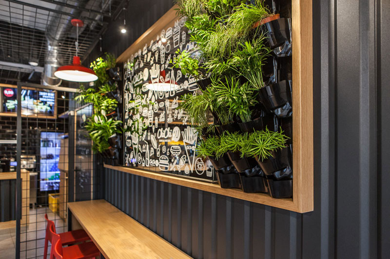 Design detail - The walls of this burger bar are covered in black corrugated steel