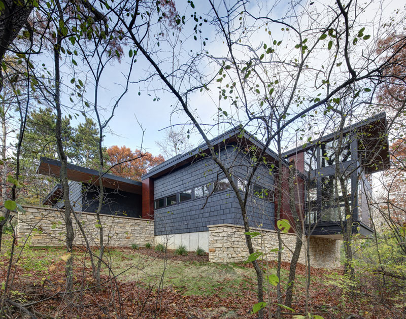 A new contemporary house in Wisconsin is covered in stone and shingles