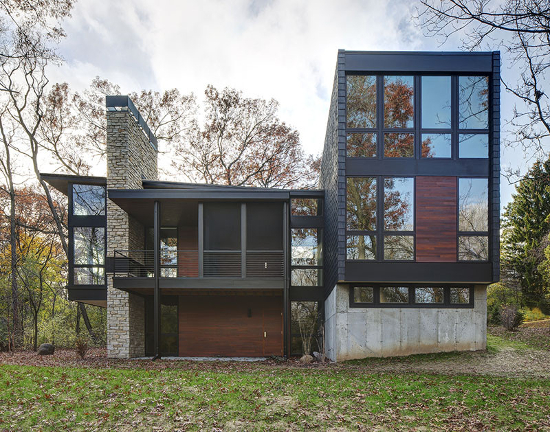 A new contemporary house in Wisconsin is covered in stone and shingles