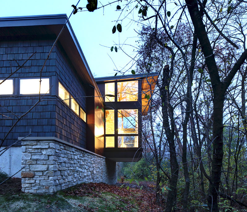A new contemporary house in Wisconsin is covered in stone and shingles