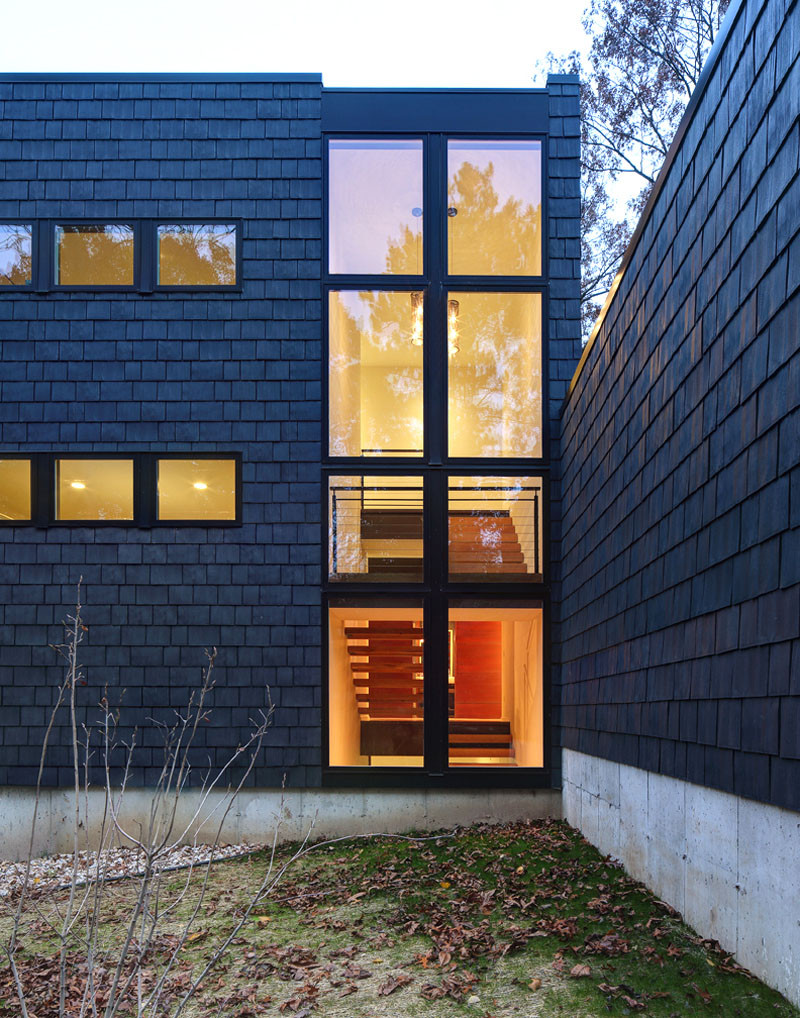 A new contemporary house in Wisconsin is covered in stone and shingles