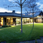 This house with a wavy roof was designed to merge with nature