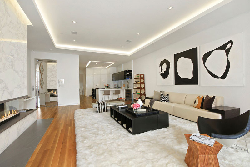 Illuminated drop ceilings emphasize the height inside this New York apartment