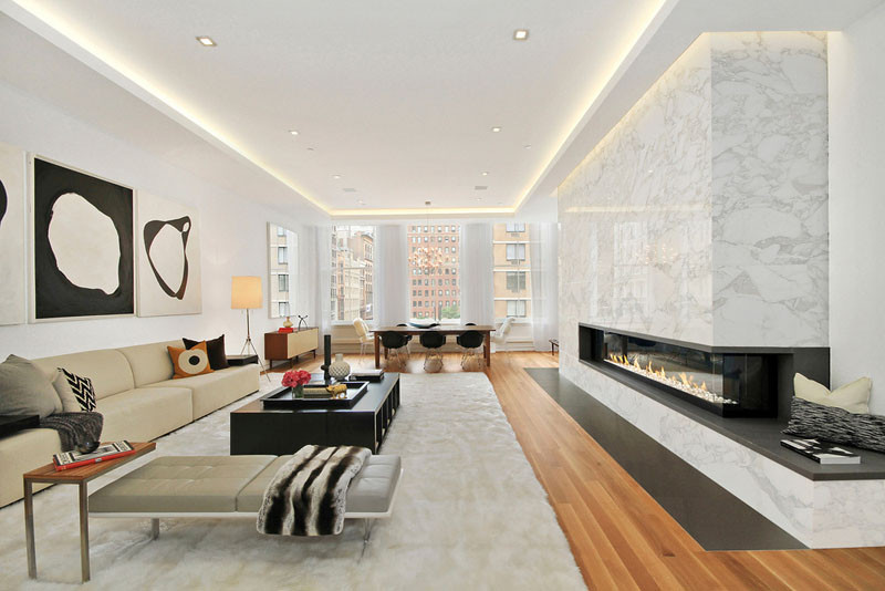 Illuminated drop ceilings emphasize the height inside this New York apartment