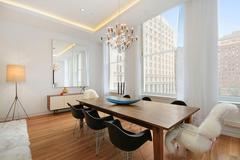 Illuminated drop ceilings emphasize the height inside this New York apartment