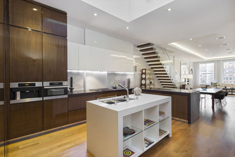 Illuminated drop ceilings emphasize the height inside this New York apartment