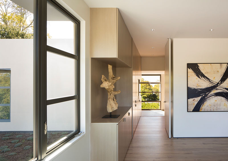 Built-in cabinetry adds extra storage in the hallway of this modern house. #Hallway #Storage #Cabinets