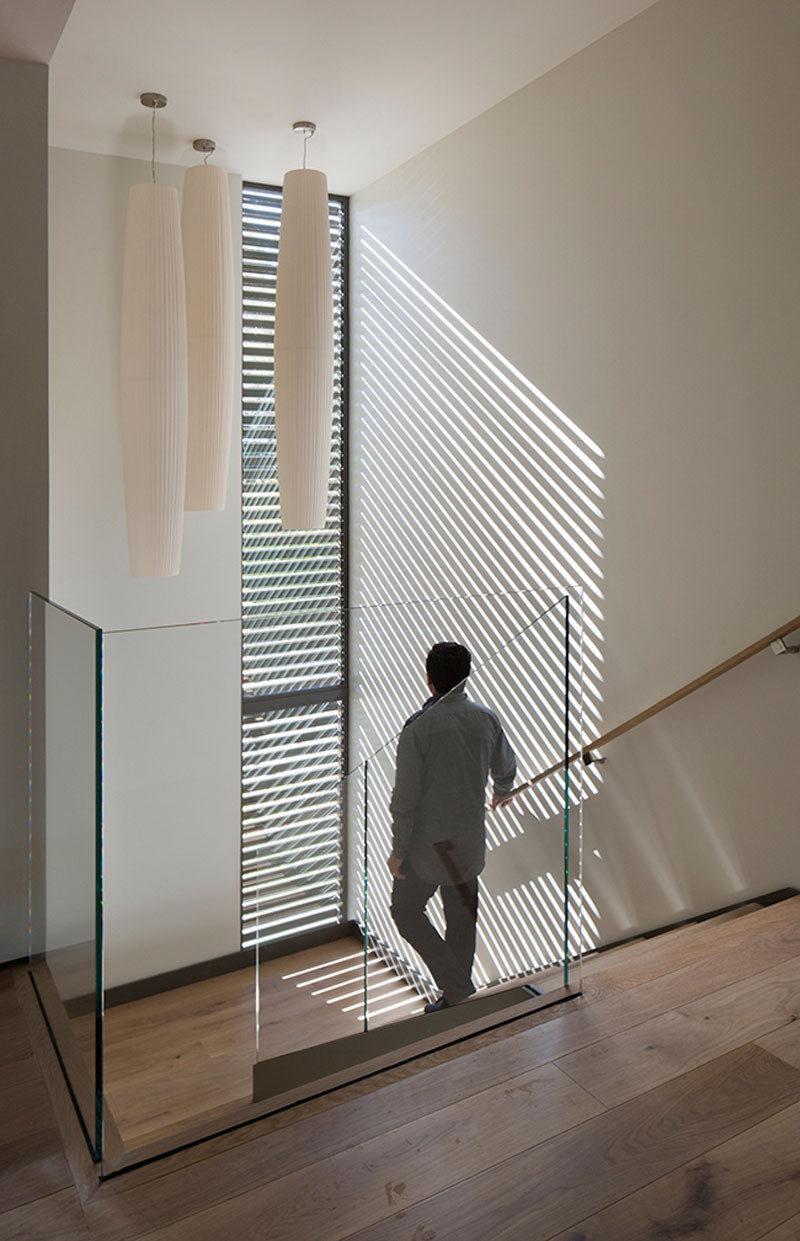 At night, this screen emits horizontal stripes from the stairwell’s lighting, creating a lantern effect seen by anyone on the exterior of the home. #Windows #Screens #Stairs