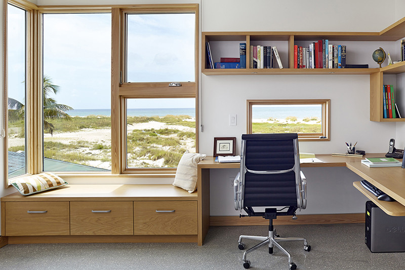 The desk areas in this home have little windows to distract you with views of the beach