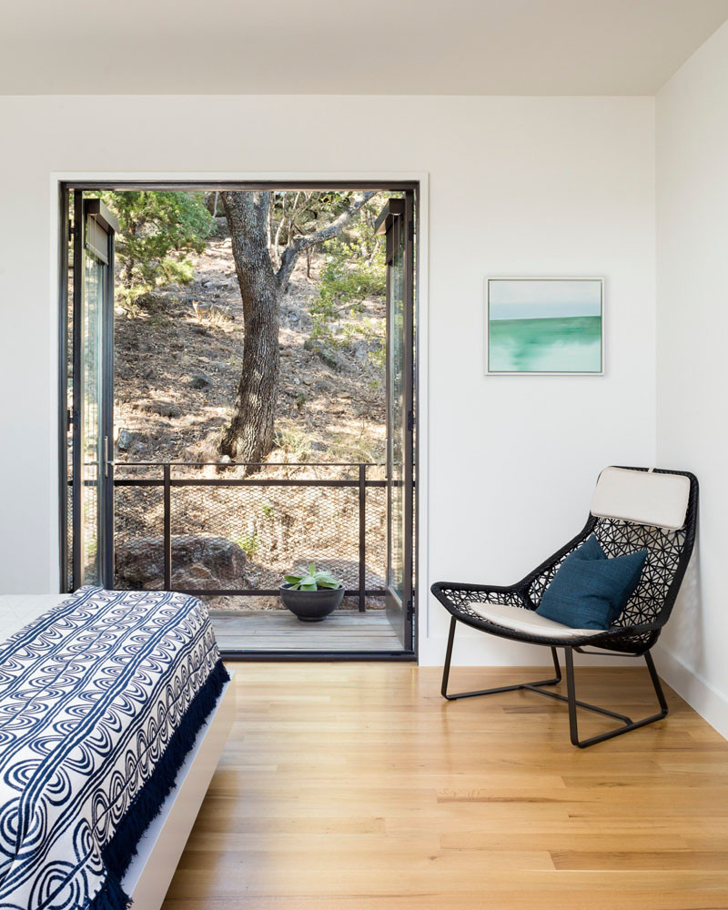 This home in Marble Falls, Texas, has a small walkout balcony from the bedroom. // Blue Lake Retreat by Lake|Flato Architects