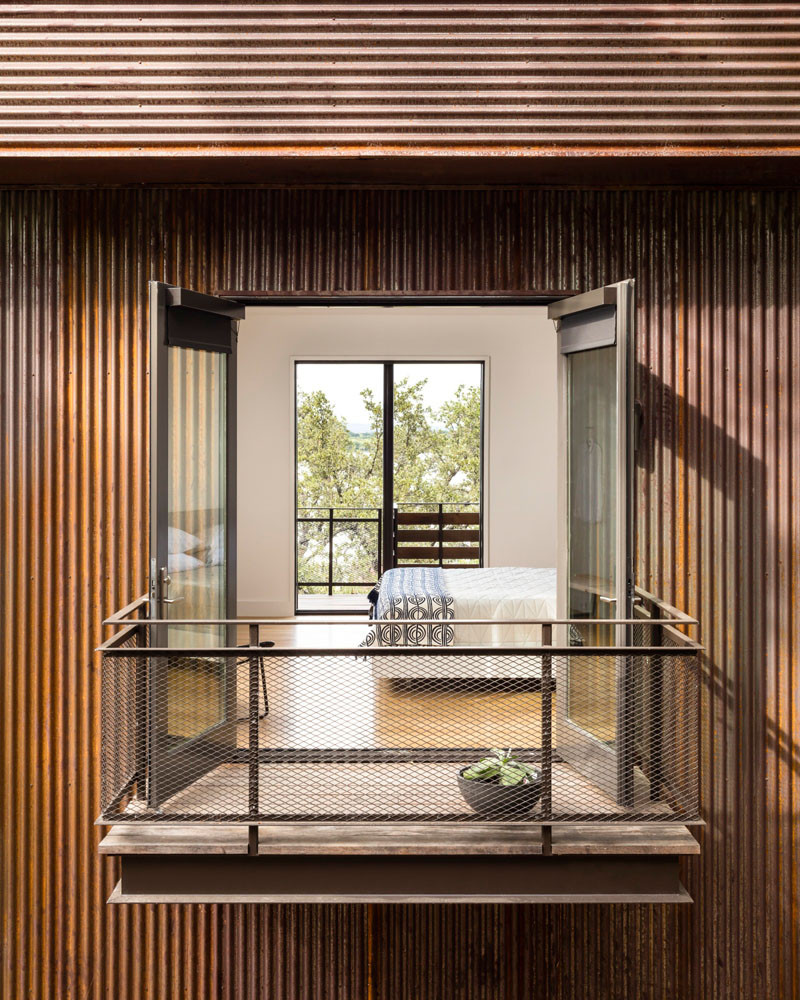 This home in Marble Falls, Texas, has a small walkout balcony from the bedroom. // Blue Lake Retreat by Lake|Flato Architects