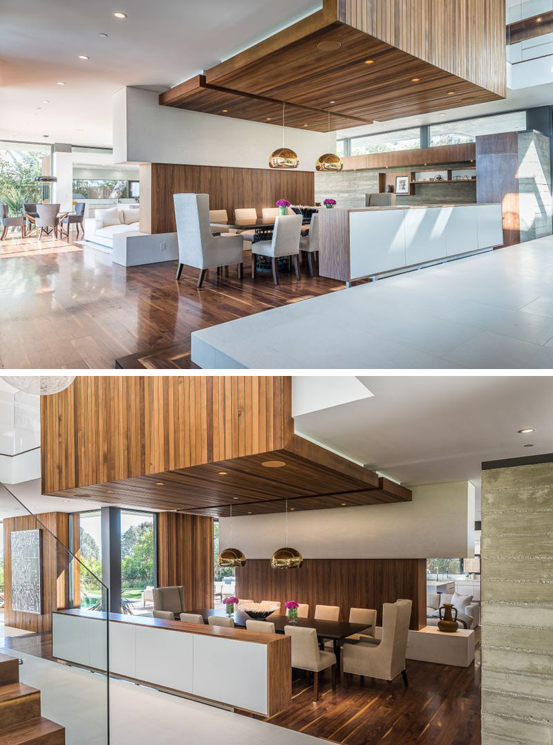 This open dining room has a wooden feature ceiling.