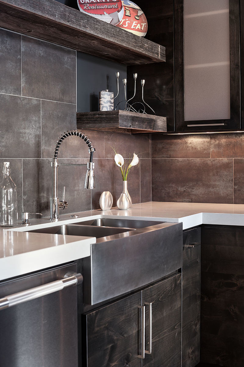 You can add a stainless steel farmhouse sink to create a more industrial look in a kitchen.