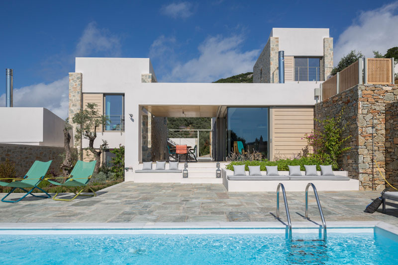 Built-in benches with cushions provide extra seating around the pool.