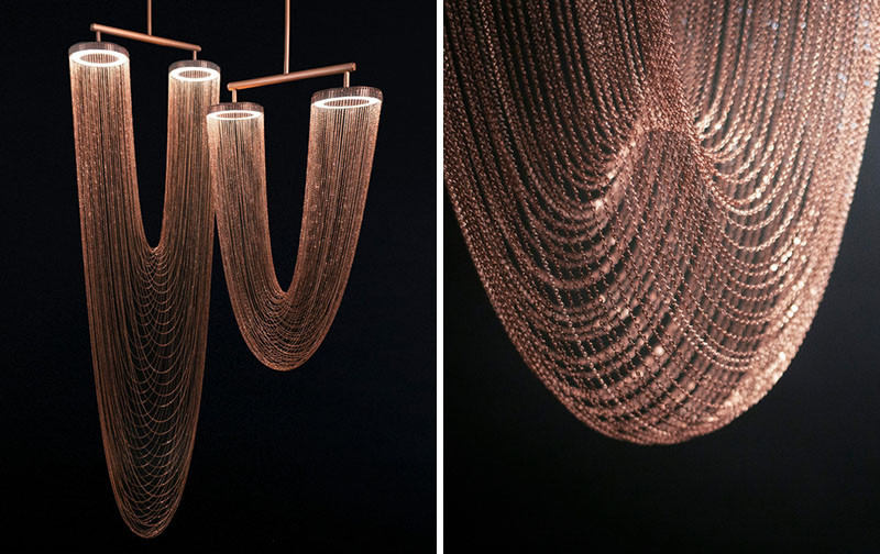 These sculptural lights are made from delicate copper plated chains that hang from two circular forms to create a unique curved shape, all of which is illuminated by a ring of LED lights. #Lighting #SculpturalLighting #LightingDesign #Chandelier #CopperLighting