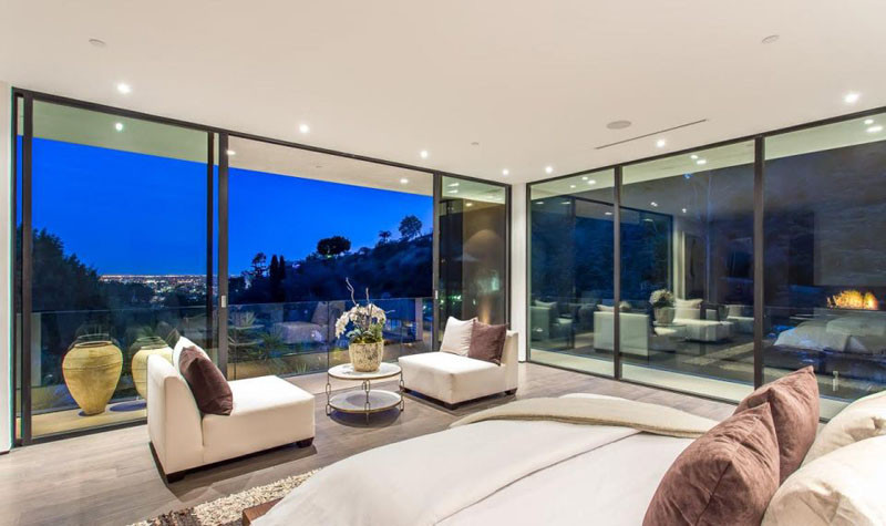 Walls of glass provide the bed with an uninterrupted view of the sparkling city lights.