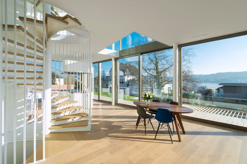 A small wooden dining table separates the kitchen and living room in this home.