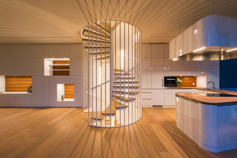 This lit up spiral staircase is like a piece of art in this home.