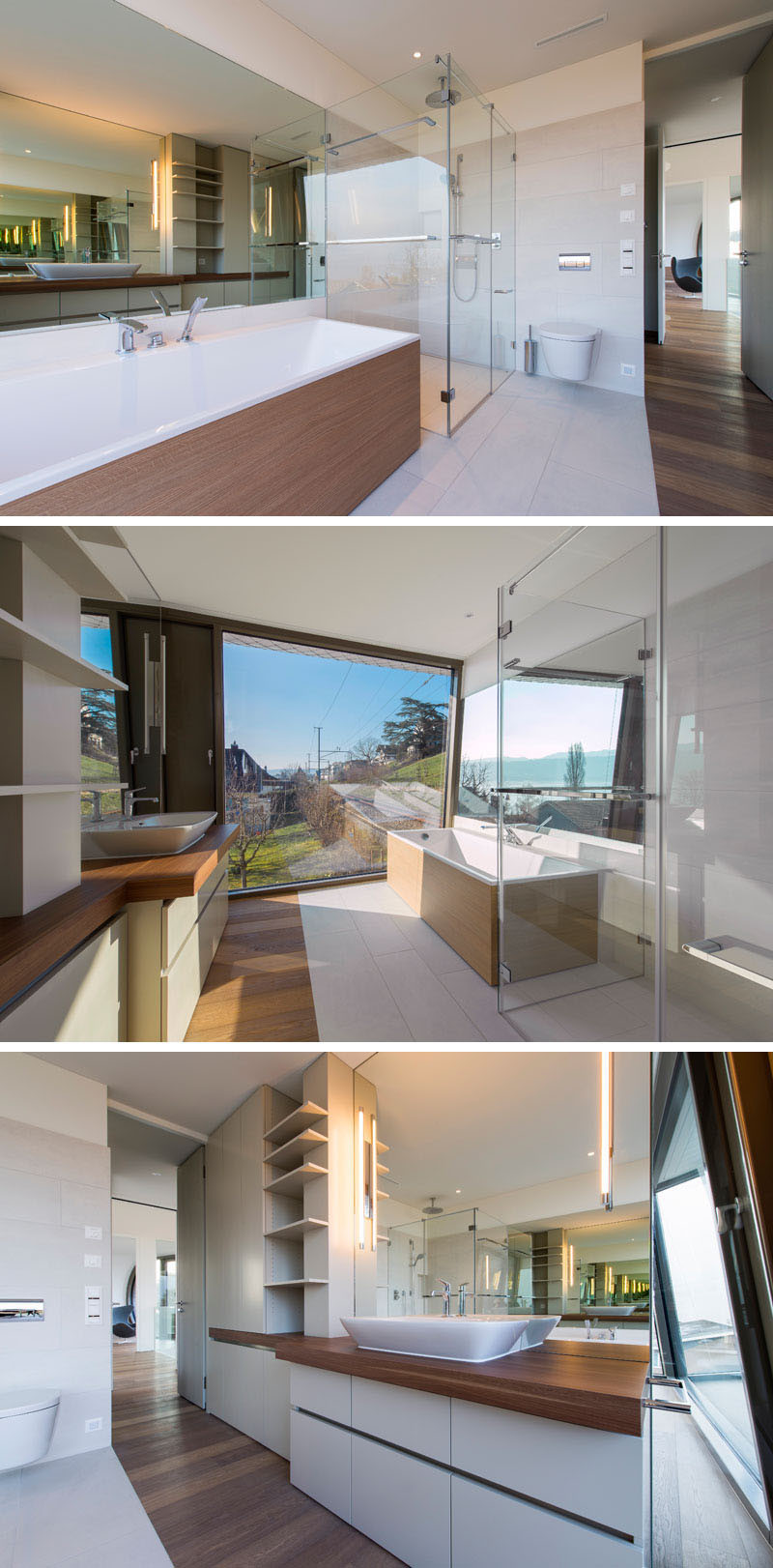 In this master bathroom, there's a glass-enclosed shower, a bathtub with a wooden surround, and a large picture window to allow plenty of natural light to fill the space.