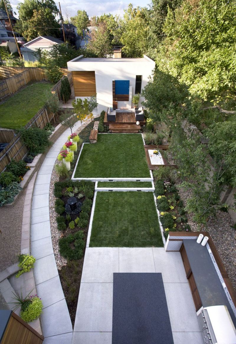 16 Inspirational Backyard Landscape Designs As Seen From Above // This backyard has a number of defined areas, like a seating area, sandbox, and outdoor kitchen, that allow for entertaining, chatting, playing, and gardening. #Backyard #YardIdeas #LandscapingIdeas #YardLayout #YardDesign