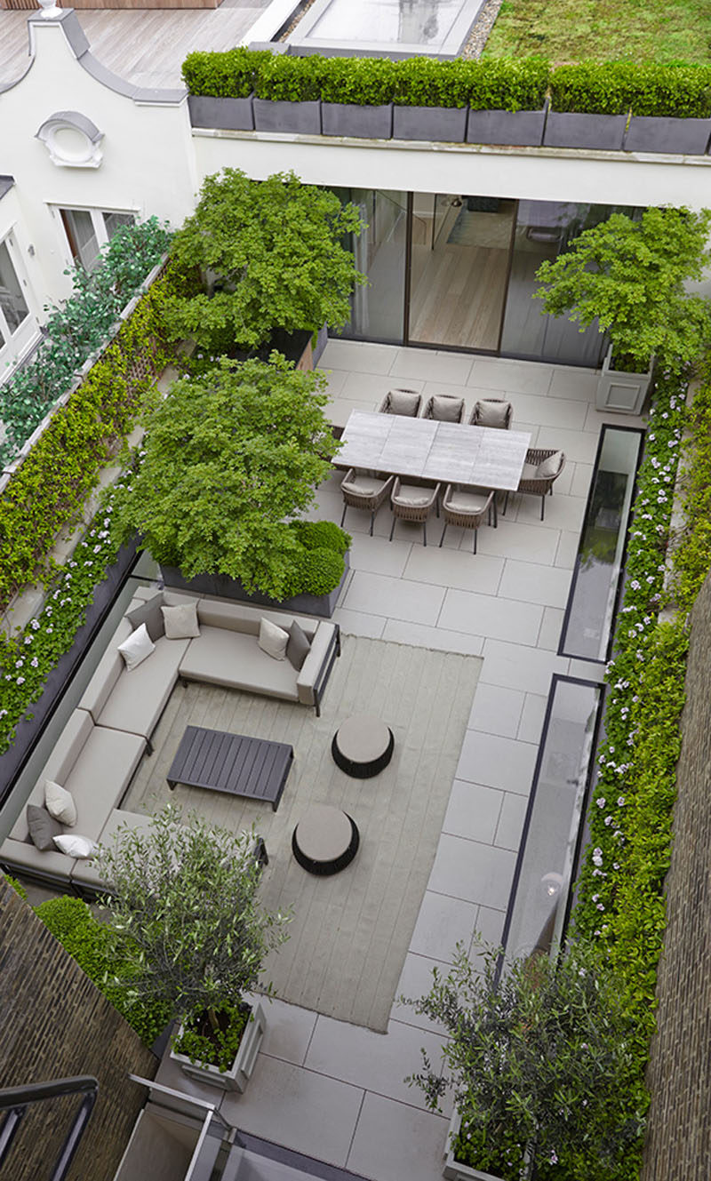 16 Inspirational Backyard Landscape Designs As Seen From Above // This space is more a patio than a backyard but the basic principles still apply - there's an outdoor dining area and a place for catching up on the couch. #Backyard #YardIdeas #LandscapingIdeas #YardLayout #YardDesign